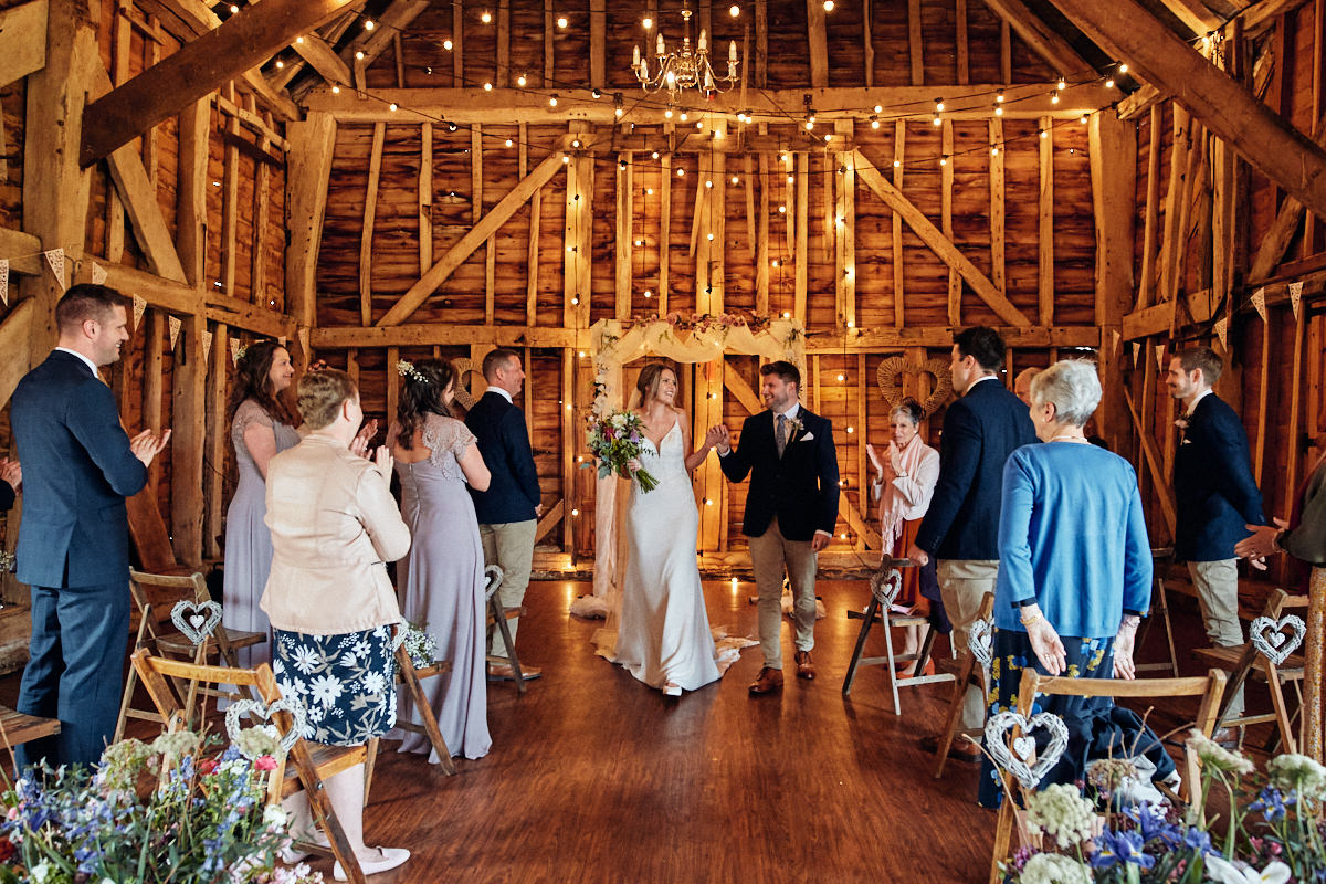 Bride and groom recessional at Great Barn in Rolvenden Kent