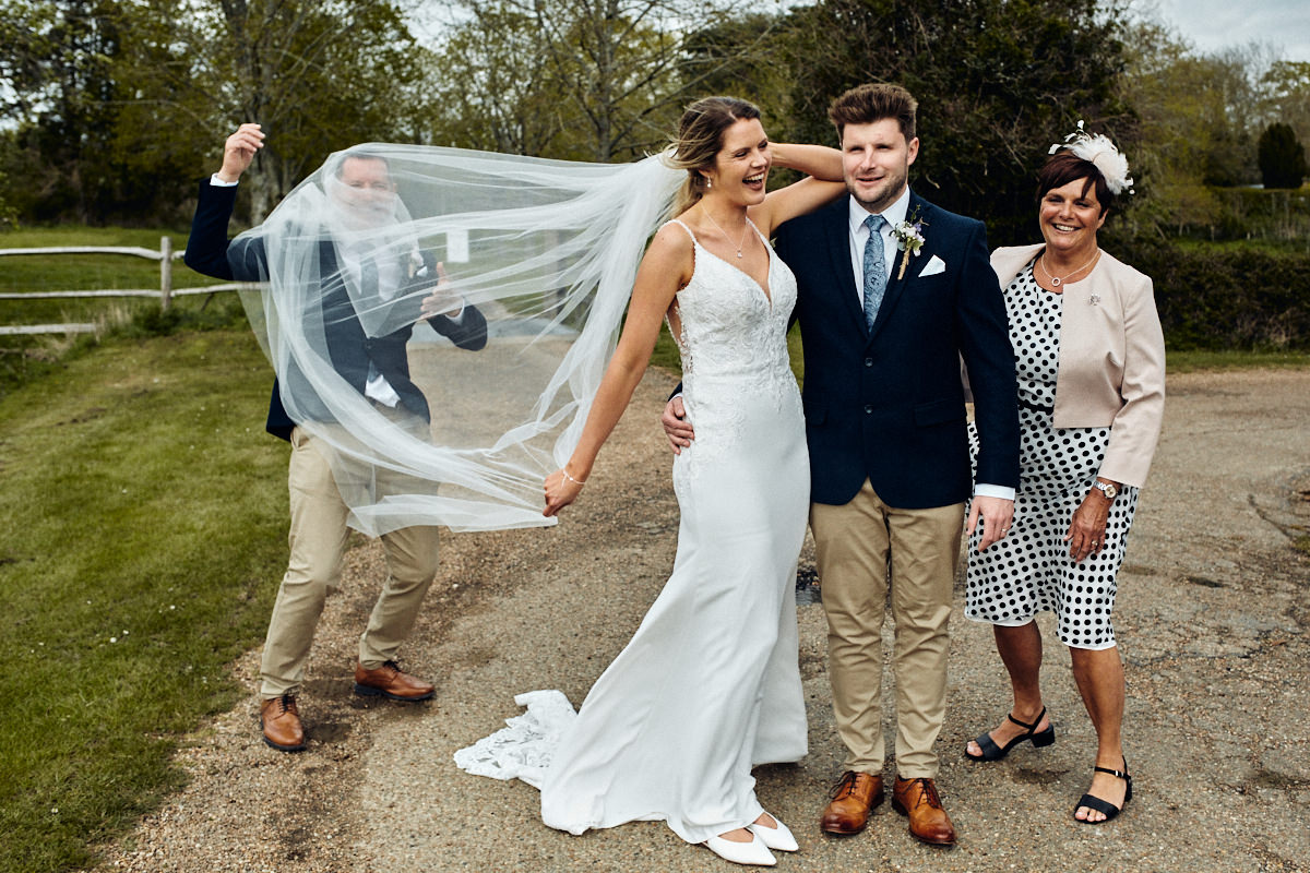Funny photo of bride's veil covering dad's face