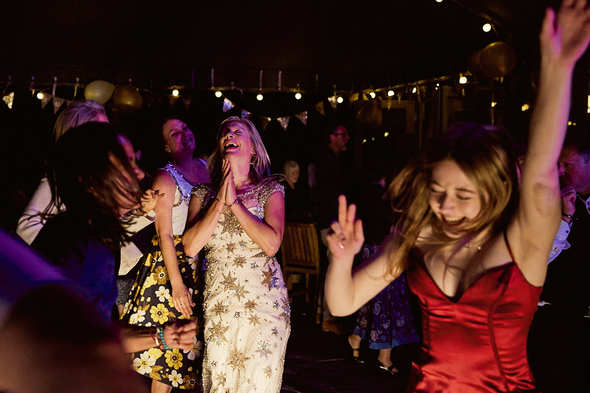 Ecstatic guests dancing at Welldiggers arms pub wedding in Petworth, Sussex