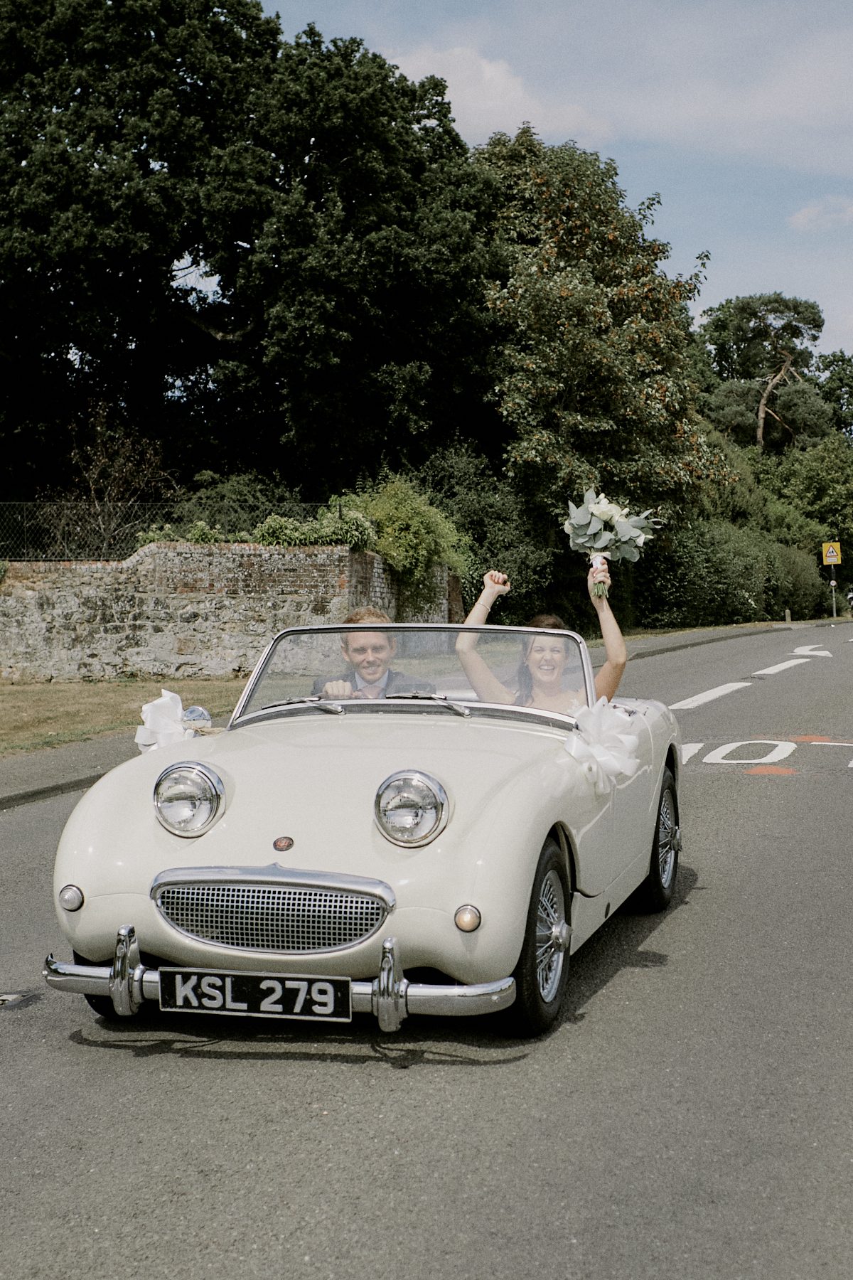 Bride and groom drive to their Ramster Hall wedding in Surrey